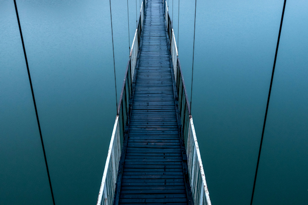 empty bridge over water by Maria Teneva