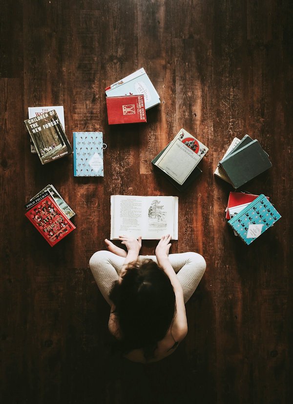 girl reading from above by Annie Spratt