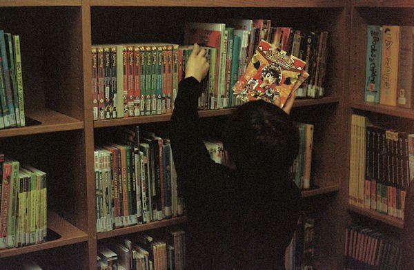 kid getting book off shelf by Keren Fedida (detail)
