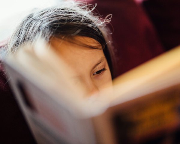 girl reading book by Johnny Mcclung (detail)